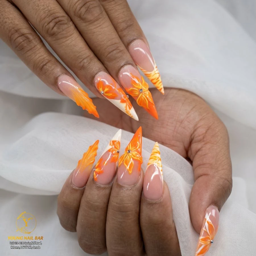 Orange sculpted flower nail art at Young Nail Bar